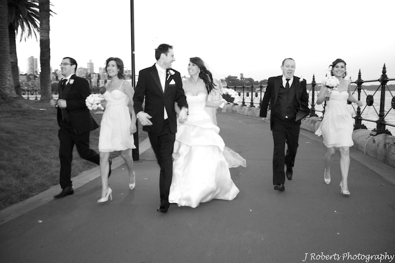 B&W Bridal party running together - wedding photography sydney